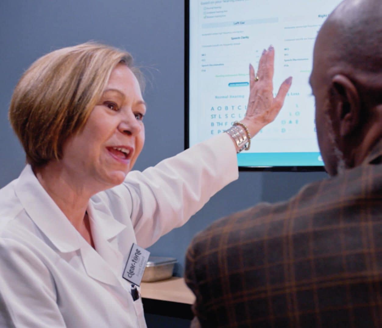 Hearing Care Provider & Patient Hearing care provider reviewing hearing test results with a patient