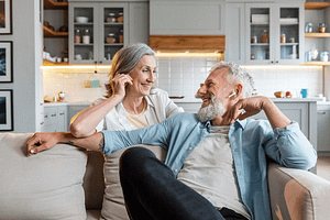 Happy couple smiling indoors, healthy lifestyle – Clear-Tone Hearing Aids
